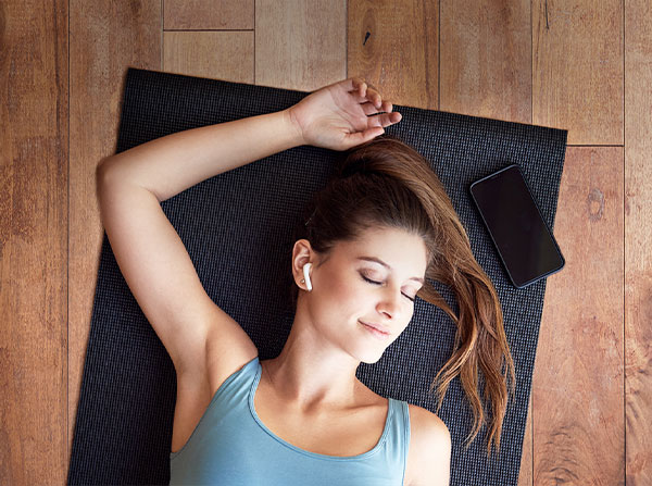 Woman laying on yoga mat